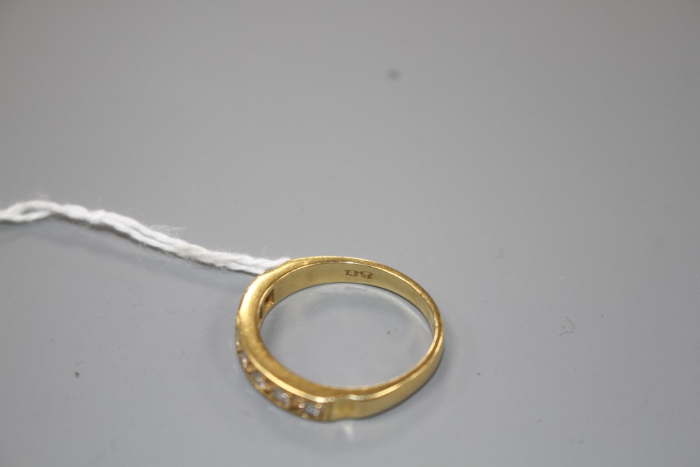 A modern 18ct gold and seven stone diamond set half eternity ring, size R, gross weight 4.9 grams.